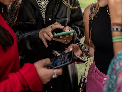 Un grupo de chicas jóvenes consultan Instagram desde sus teléfonos móviles.