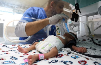 A health worker with a premature Palestinian baby lying in an incubator in the maternity ward of Al Shifa Hospital on October 22.