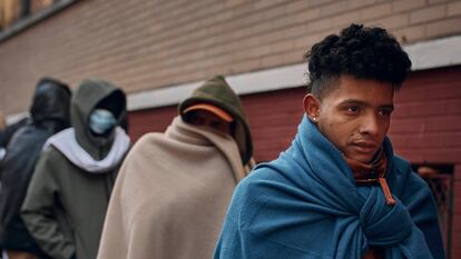 Migrants line up outside a migrant assistance center in the East Village in November 2023.