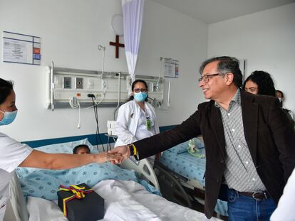 El presidente de Colombia, Gustavo Petro, saluda a una de las enfermeras que cuida a los niños hallados con vida en la selva, el domingo en Bogotá.