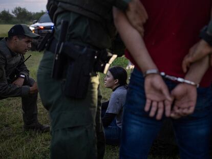 Texas state agents detain migrants who crossed the border on June 13 in Mission.