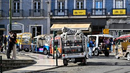 Tuk-tuks parked in Camões square await the arrival of tourists in Lisbon.