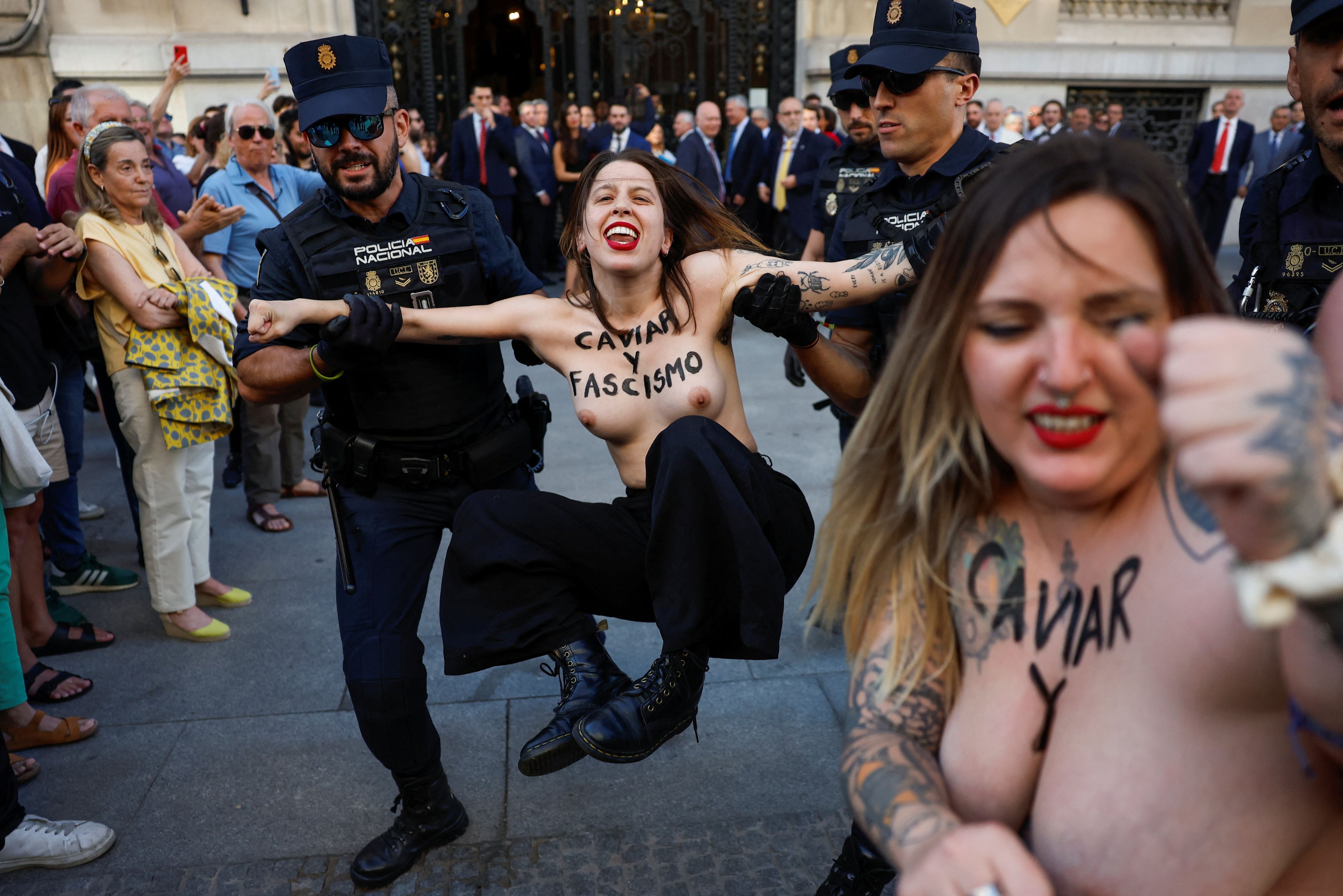 An activist from the women's rights group FEMEN is detained during a protest against the Spain visit of the President of Argentina Javier Milei, outside Casino de Madrid, in Madrid, Spain, June 21, 2024. REUTERS/Juan Medina