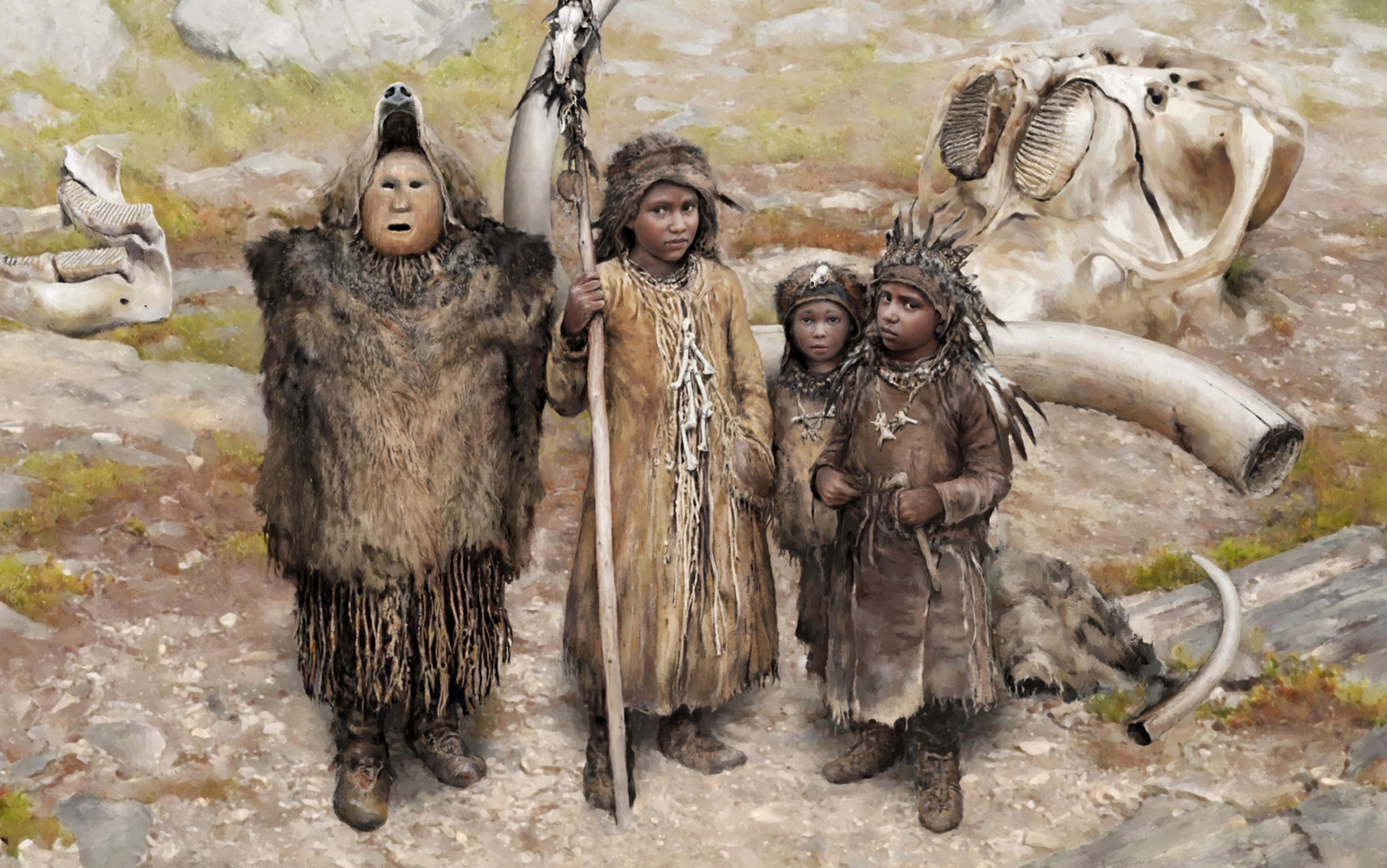 A group of four people in primitive clothing, standing in a rocky landscape with large animal bones in the background.