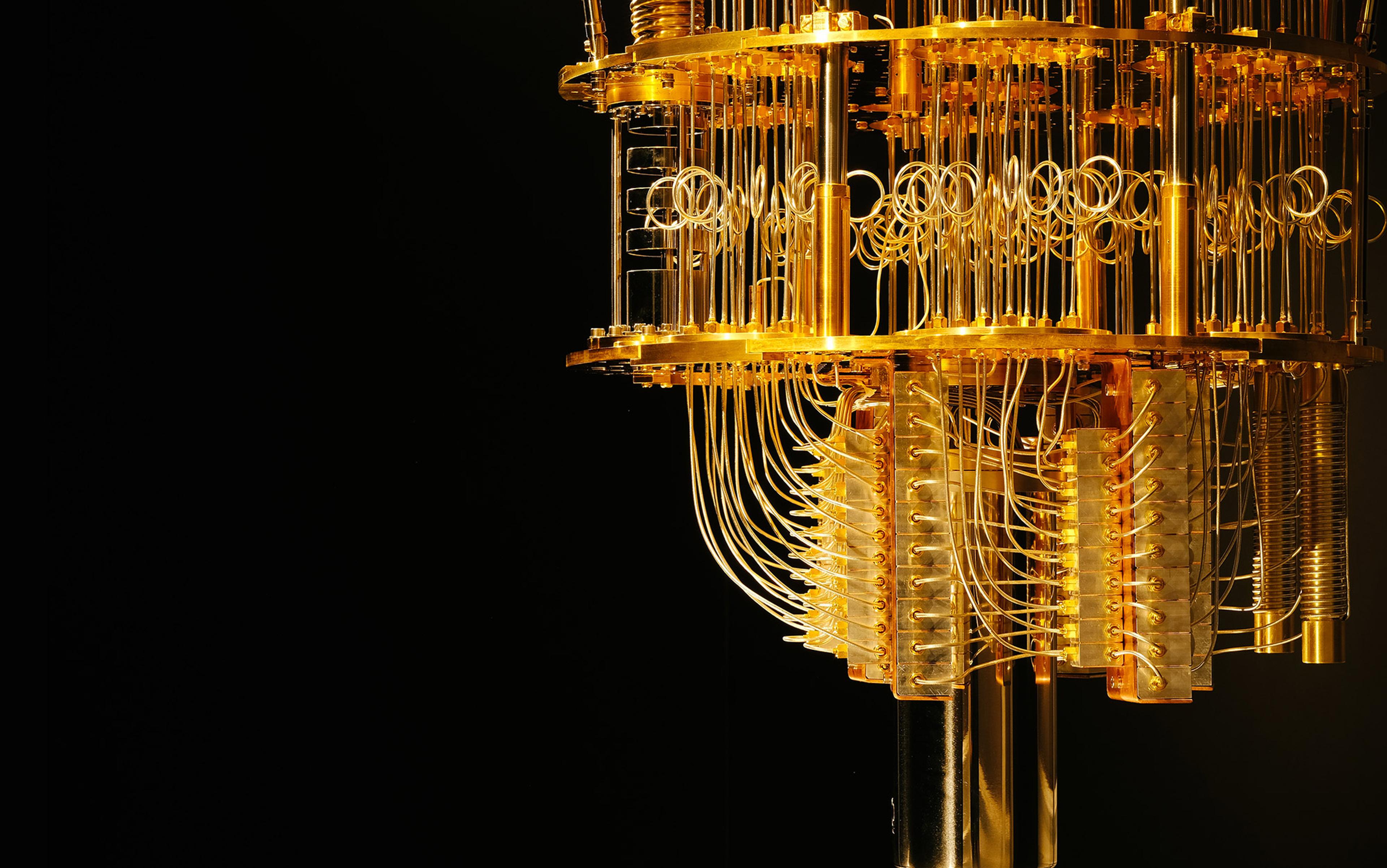 A quantum computer’s golden, intricate hardware with wires and components against a dark background, partially visible.