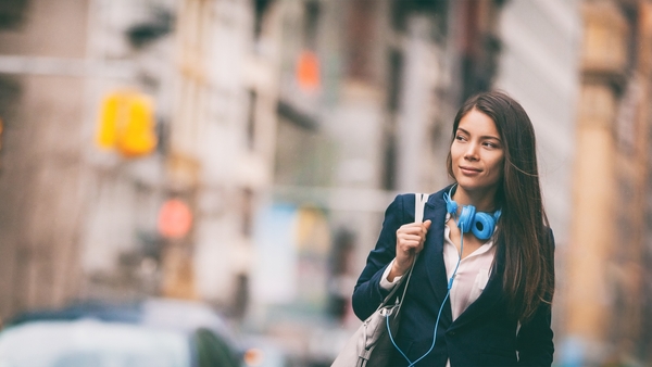 Woman walking while using safe and secure communications solutions.