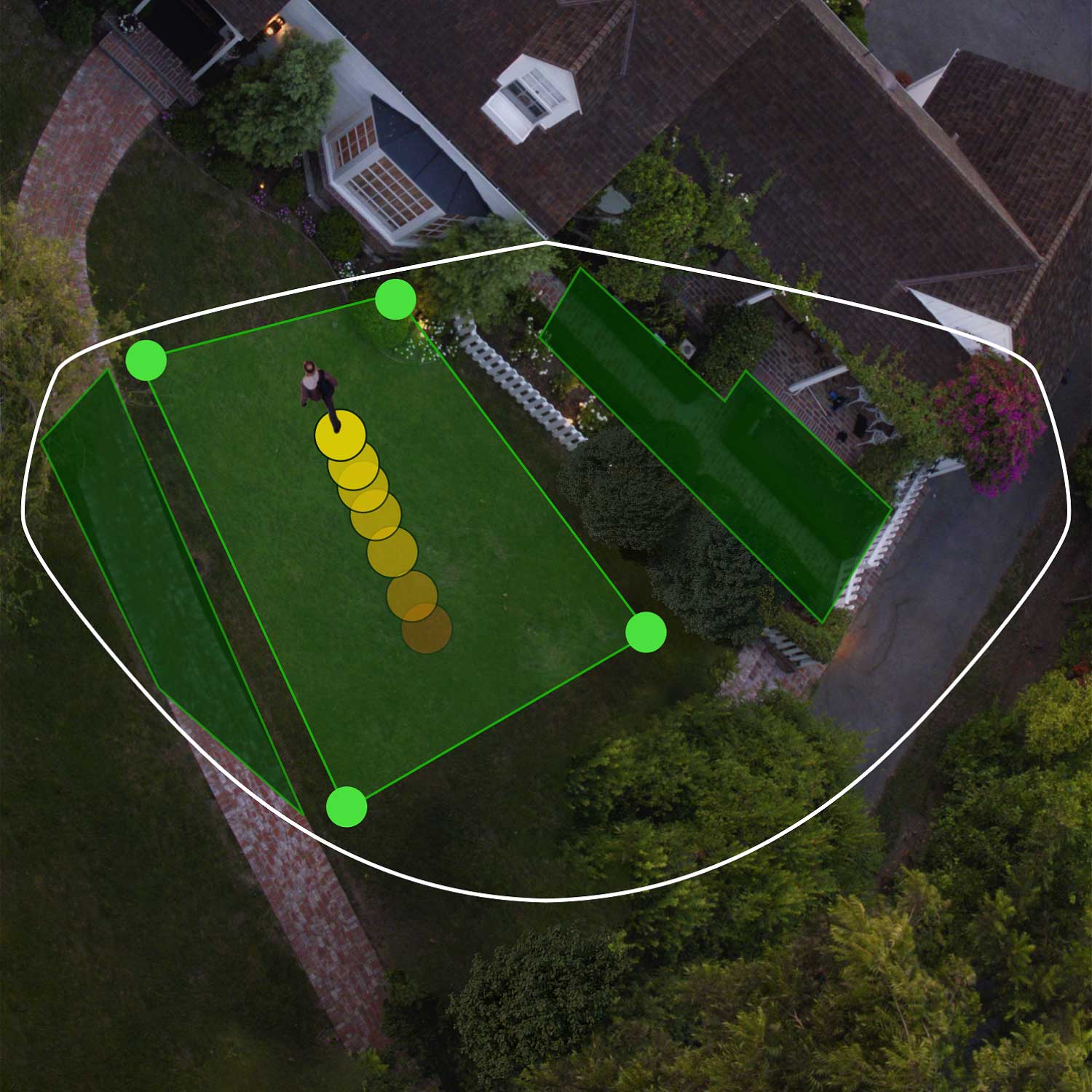 Spotlight Cam Pro - Wired:Spotlight Cam Pro Aerial view of front of house showing bird's eye view zones in green. Person walks toward front door, their path indicated by yellow dots.