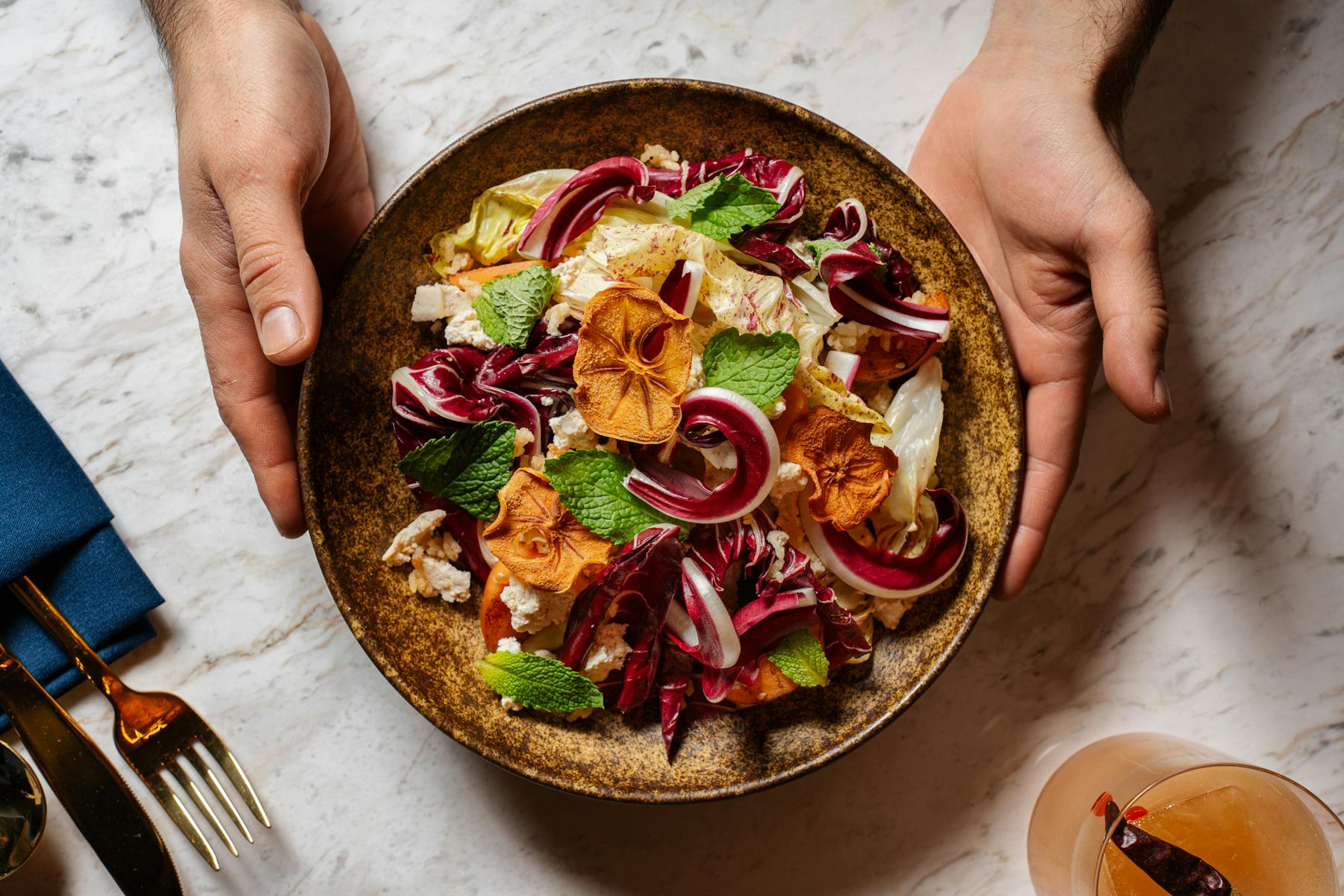 a person cutting food on a plate