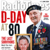 Ken Benbow holding a framed photo of himself as an Ordinary Seaman on the D-Day at 80 Radio Times magazine special