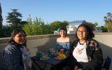 3 students eat tacos on the Mondavi Center balcony during a student social