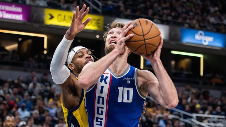 Feb 2, 2024; Indianapolis, Indiana, USA; Sacramento Kings forward Domantas Sabonis (10) shoots the ball while Indiana Pacers guard Buddy Hield (7) defends in the second half at Gainbridge Fieldhouse. Mandatory Credit: Trevor Ruszkowski-USA TODAY Sports