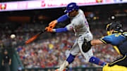 Sep 13, 2024; Philadelphia, Pennsylvania, USA; New York Mets shortstop Francisco Lindor (12) hits a single during the fifth inning against the Philadelphia Phillies at Citizens Bank Park. Mandatory Credit: Bill Streicher-Imagn Images