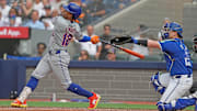 Sep 11, 2024; Toronto, Ontario, CAN; New York Mets shortstop Francisco Lindor (12) hits a home run against the Toronto Blue Jays during the ninth inning at Rogers Centre. Mandatory Credit: Nick Turchiaro-Imagn Images