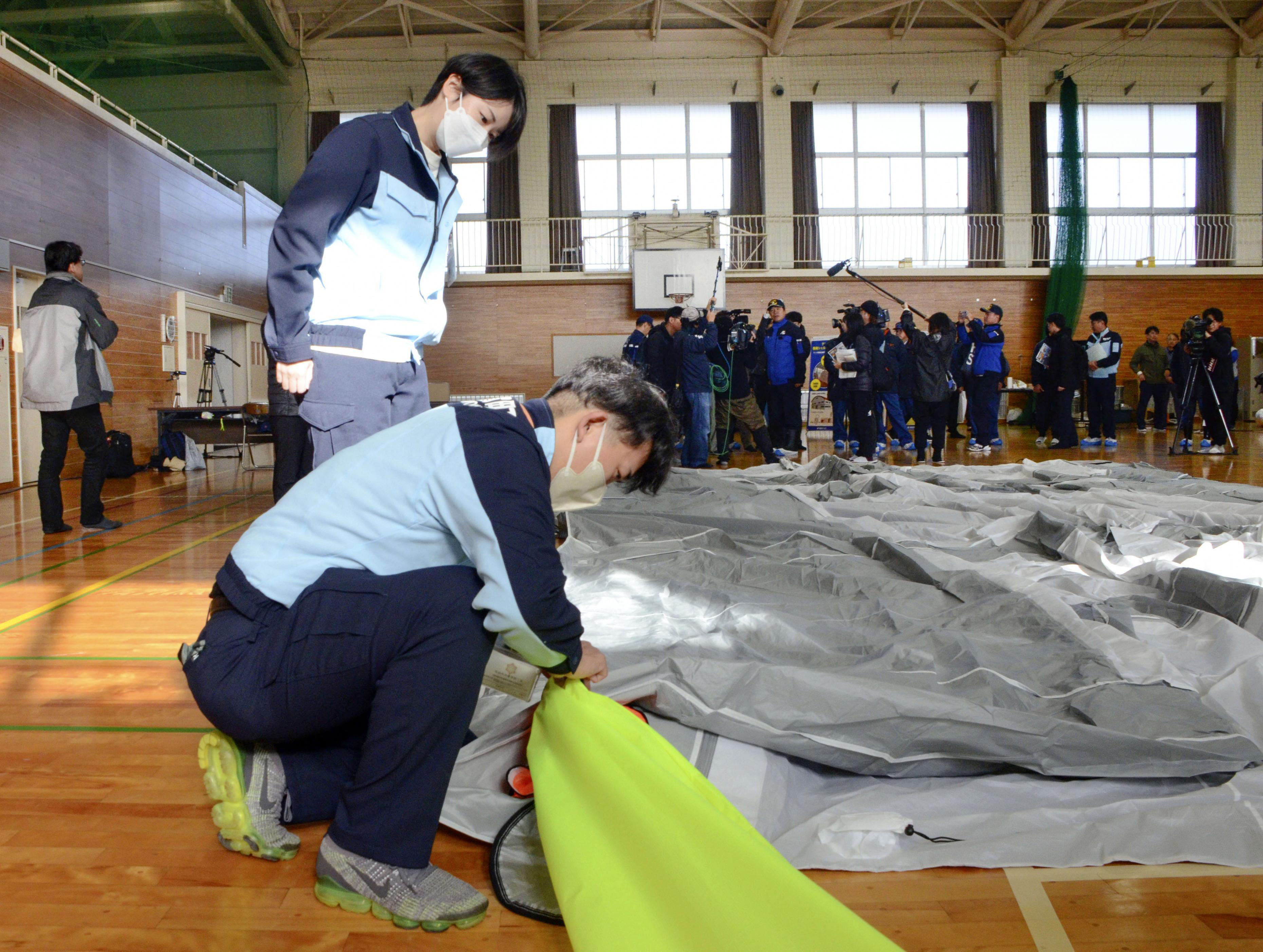 志賀原発事故を想定した防災訓練で、可搬型の防護テントを設営する担当者＝11月、石川県志賀町