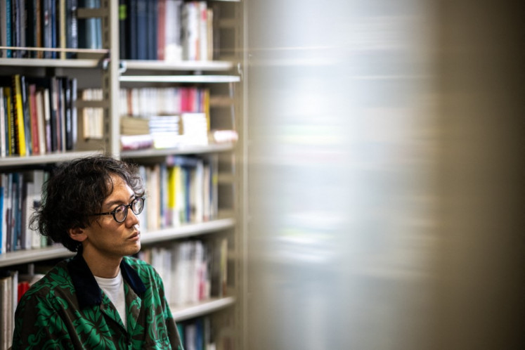 This picture taken on July 11, 2024 shows Kohei Saito, associate professor of philosophy at the University of Tokyo, speaking in his office at the University's Komaba Campus in Tokyo. 