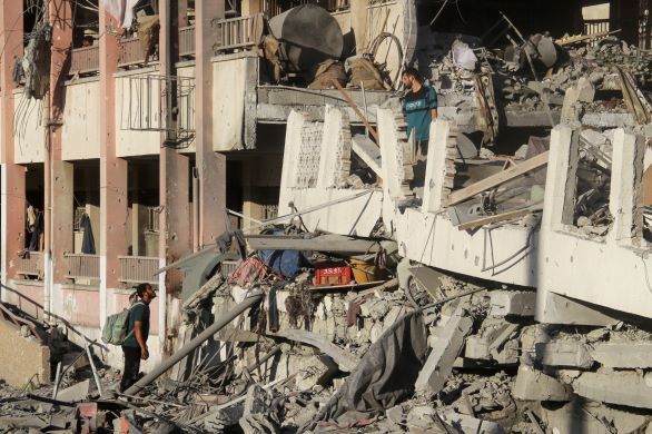 Merciless: Palestinians inspect on Aug. 3, 2024 the site of Israeli strikes on a school in Gaza City that sheltered displaced people, amid the Israel-Hamas conflict. 