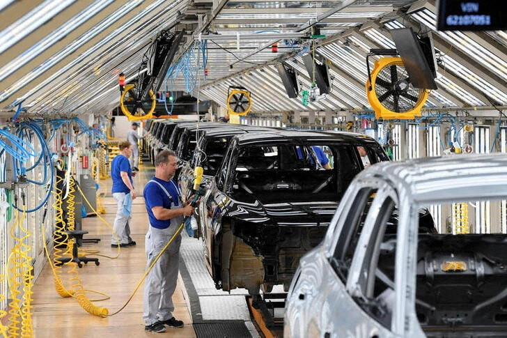 Volkswagen employee works on a production line for the Golf VIII and Tiguan cars at the VW headquarters in Wolfsburg, Germany, on May 23, 2024.