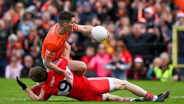 Jarly Óg Burns and Brendan Rogers battle for possession during last year's Ulster final