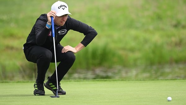 Tom McKibbin lines up a putt at the seventh hole on the second day of the European Open in Hamburg