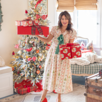 Jillian Harris holding gifts in front of Christmas tree