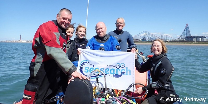 Divers on a boat with a Seasearch flag