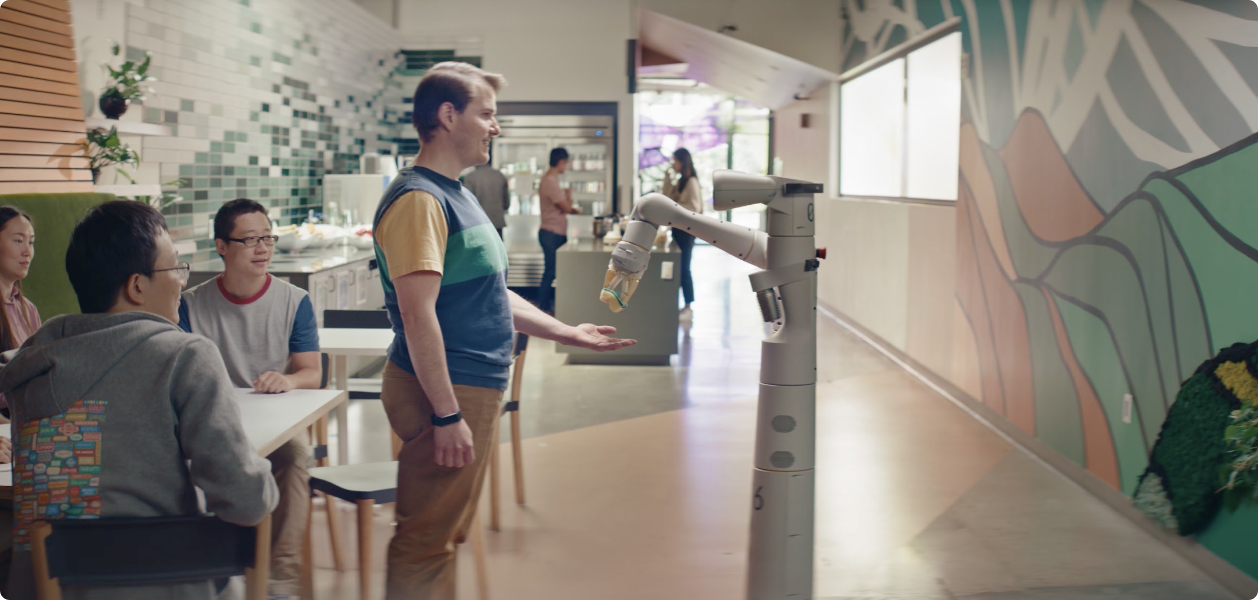 Google researchers and an Everyday Robots helper robot working together to complete various tasks.