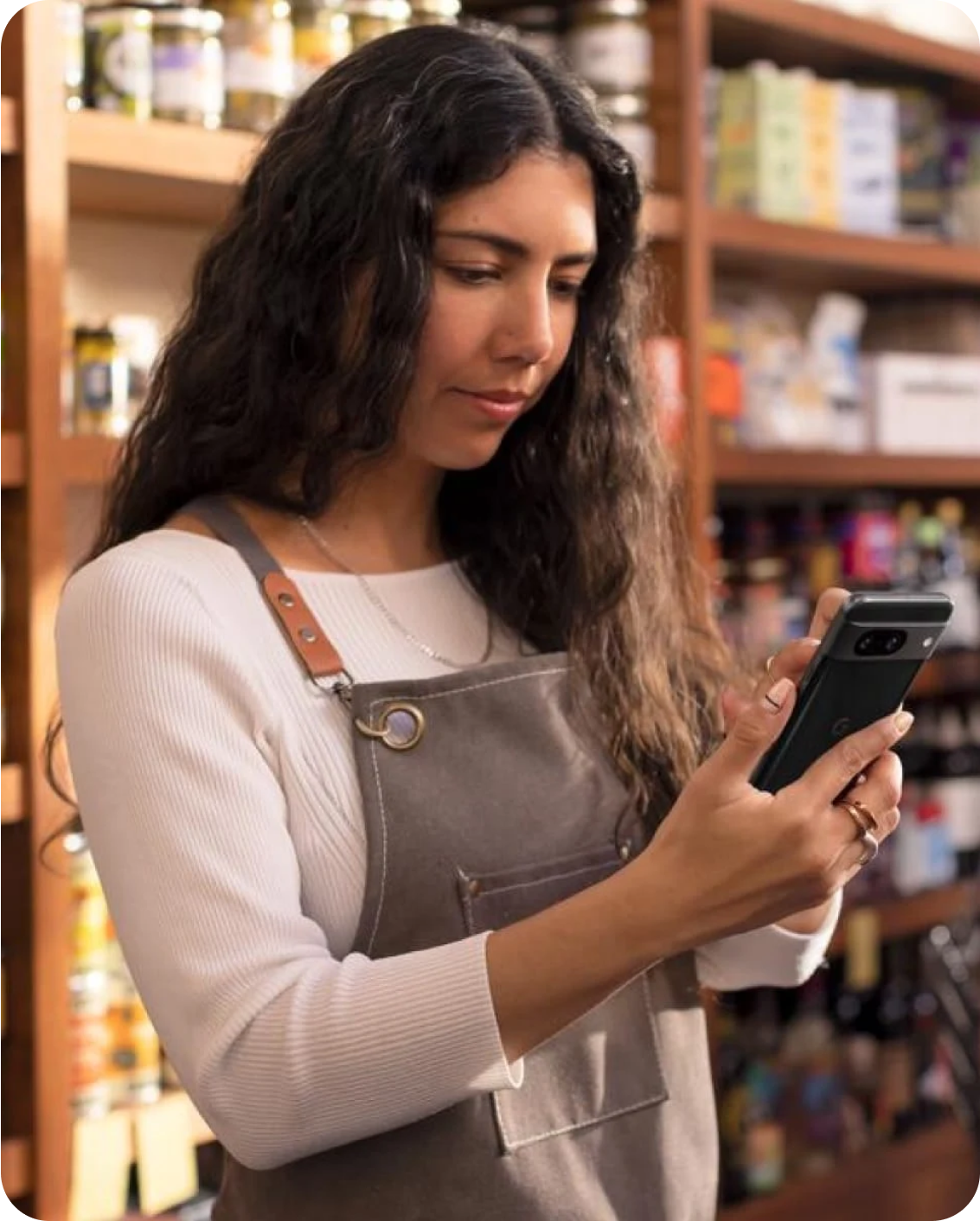 Woman in a shop working on her Pixel phone.