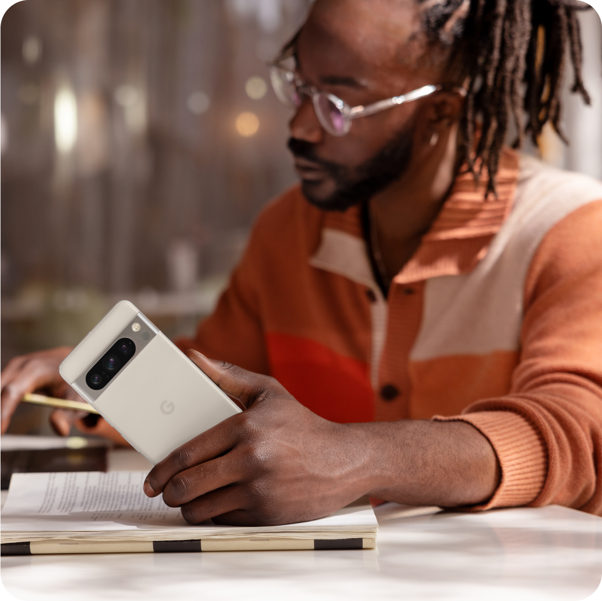 A man using a Google Pixel 8 phone to work.