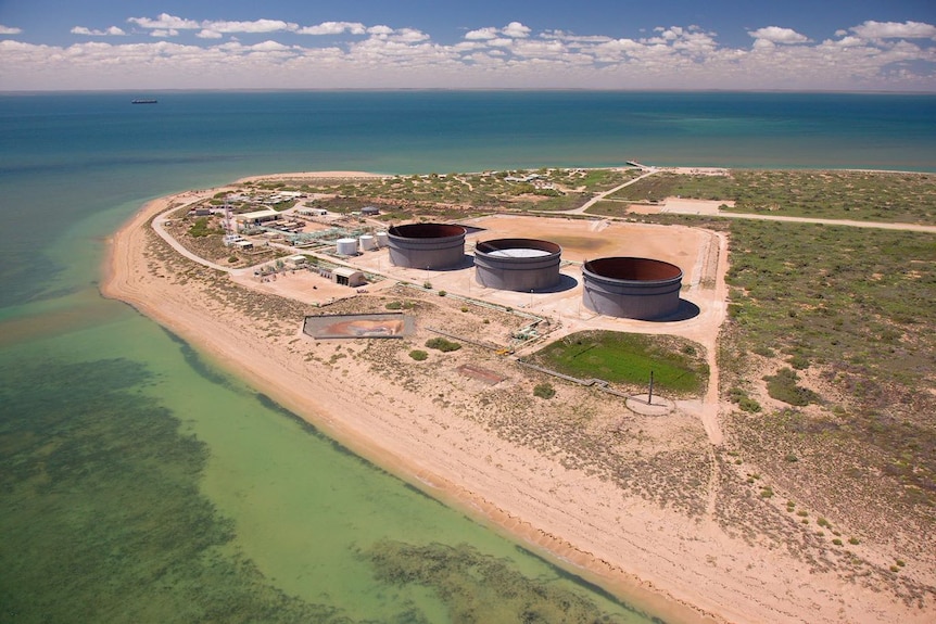 A drone shot of large oil tanks and processing facilities.