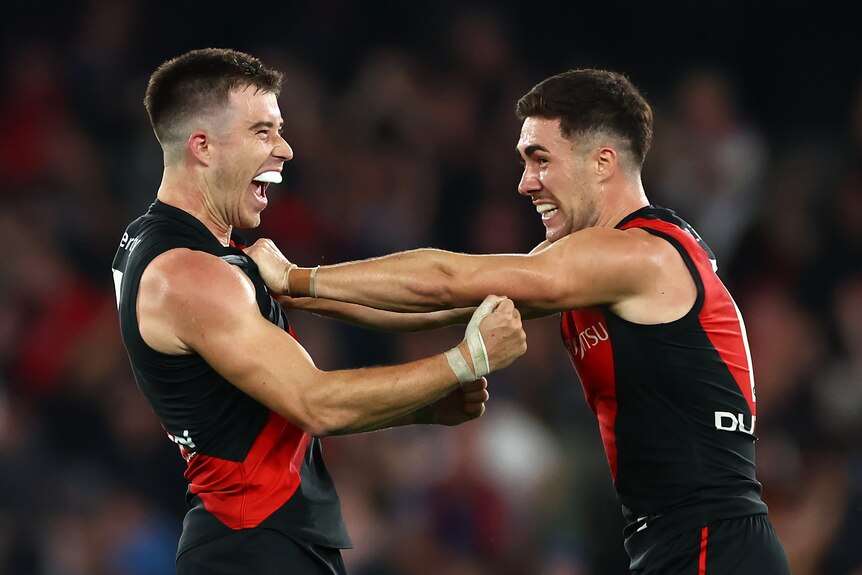 Zach Merrett and Jade Gresham celebrate