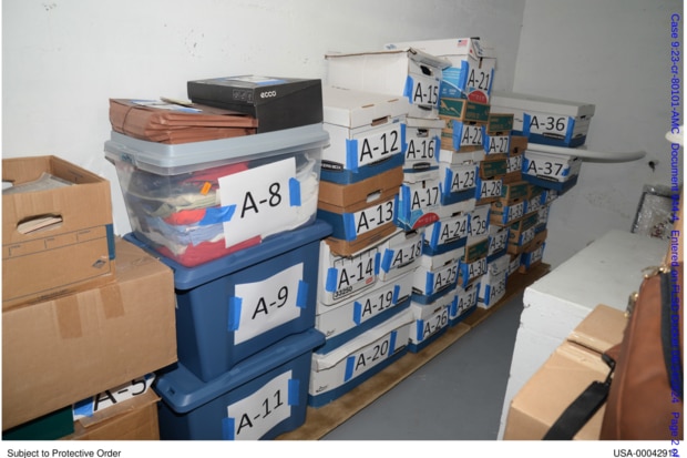 Boxed stacked on top of each other against a wall and labelled with letters and numbers