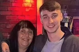 Jay Slater wraps his arm around his mother's shoulder as the pair smile for a photo. 