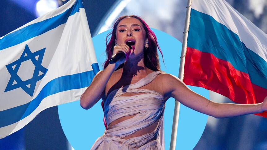 A woman in a bandaged-style dres sings into a microphone on a stage with an Israeli and a Russian flag either side of her.