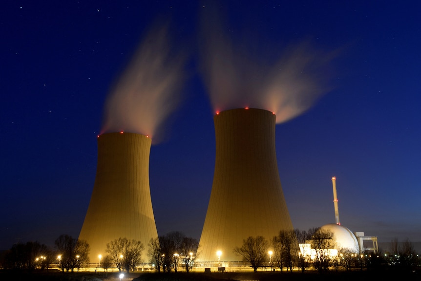 Two nuclear power buildings in the night.