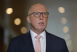 A close up shot of Peter Dutton in glasses.