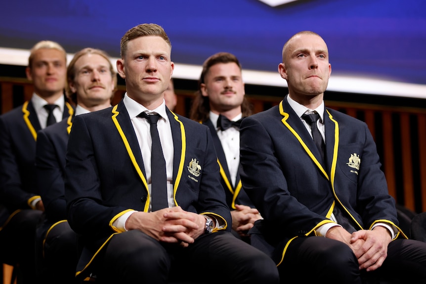 James Sicily and Callum Wilkie sit in their All-Australian blazers at the AFL Awards night.