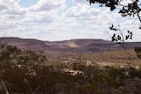 A wide shot of a large mine off in the distance.