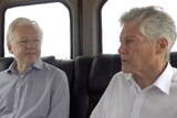 Three men sitting in the back of a car, talking