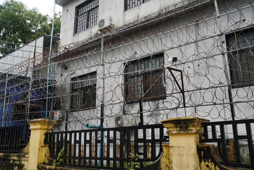 Barbed wire fences are seen outside a shuttered compound. 