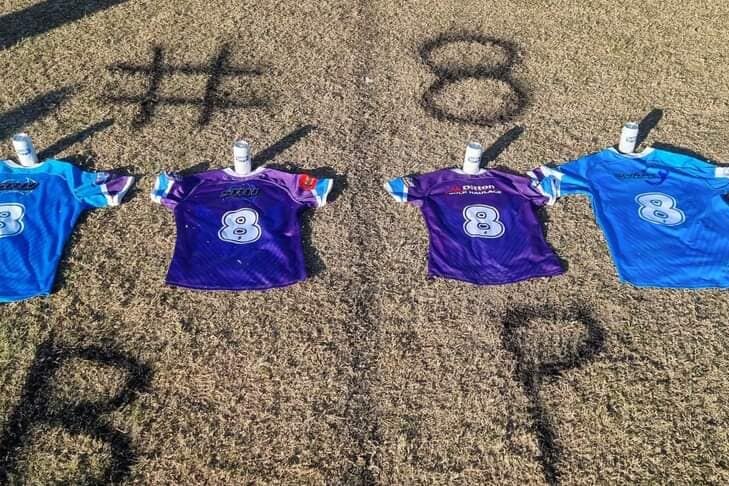 Four Aberglasslyn Ants rugby league jerseys, each bearing a number eight, lie on the grass.