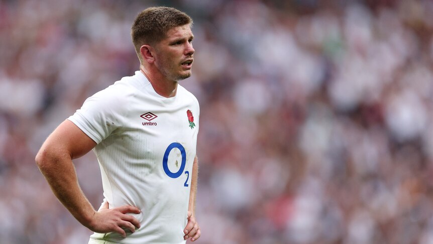 Owen Farrell stands with his hands on his hips