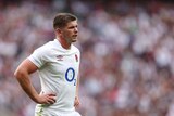 Owen Farrell stands with his hands on his hips
