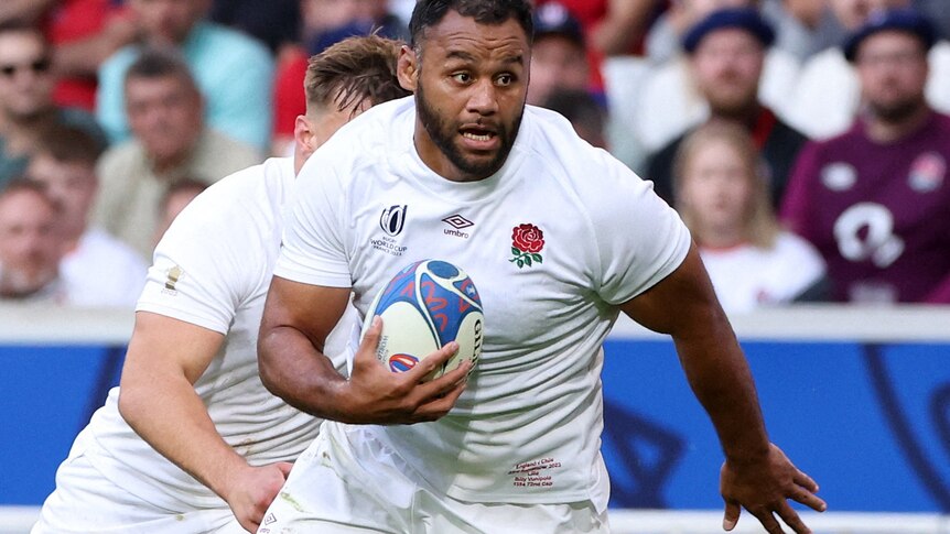 Rugby Union player Billy Vunipola, during a match for England, runs with the ball under his arm