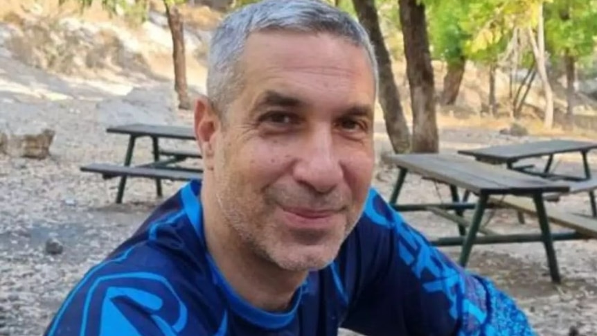 A man in blue shirt smiling. 
