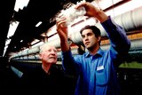 A man and his grandfather in a wool mill