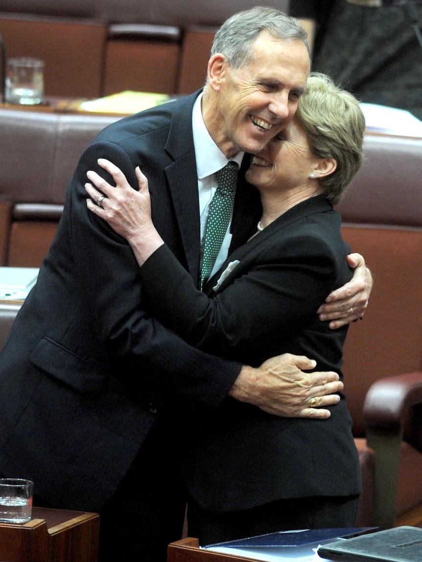 Senator Bob Brown and Christine Milne hug after the carbon tax legislation was passed in the Senate.
