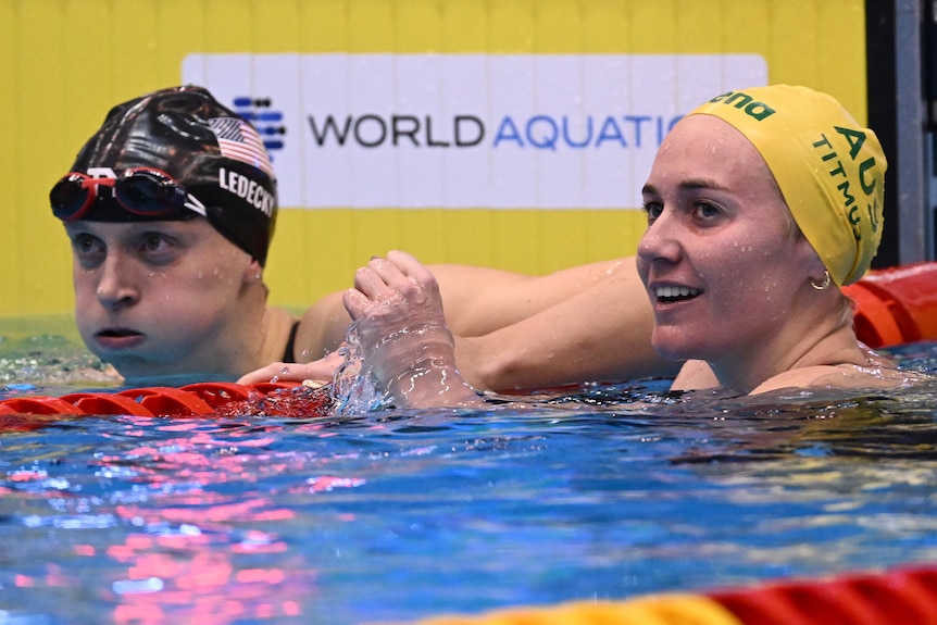 Ariarne Titmus smiles next to Katie Ledecky