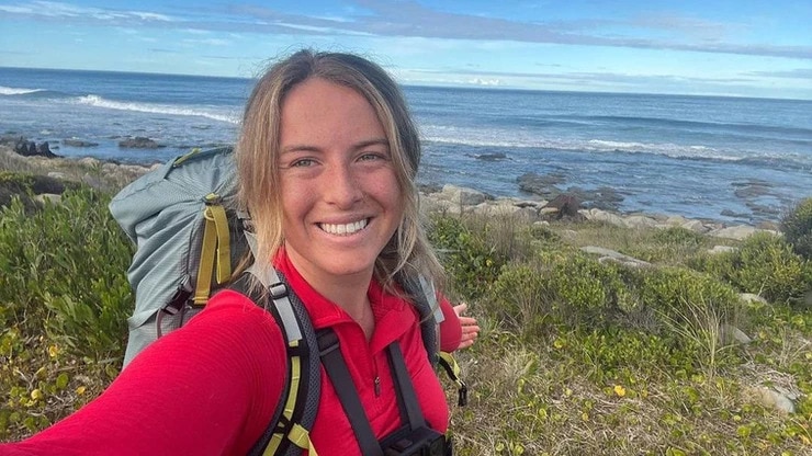 Smiling blonde woman outside on a beach