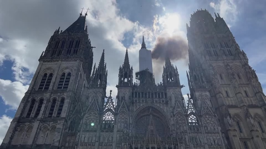 A cathedral with black smoke 