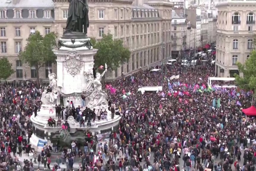A crowd of people fill a square in Paris.